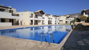 Very large outdoor communal pool with large space around for sunbathing 