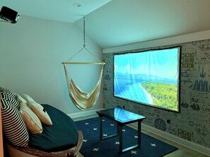 "Shipwrecked" custom boat & hanging chair in upstairs with 100" movie screen!