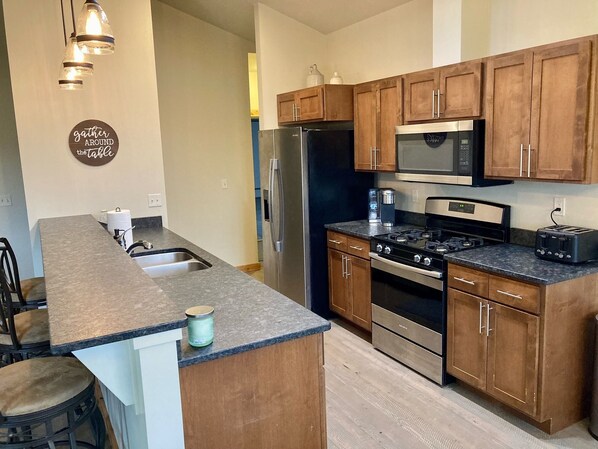 Full kitchen with Keurig, microwave, toaster and dishes/cookware. 