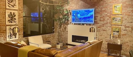 Stunning exposed brick with cozy seating and 65" LG OLED TV