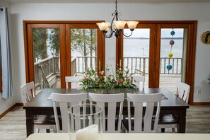 Large kitchen island overlooks the dining area and waterfront deck