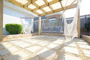 Pergola area has nostalgic bistro lighting that turns on automatically at dusk. 