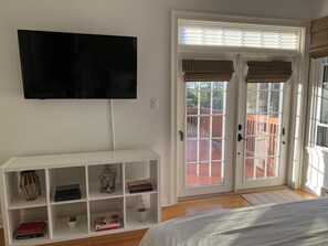 French doors in primary bedroom leading to backyard deck