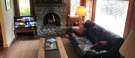 Living room with working fireplace & smart TV