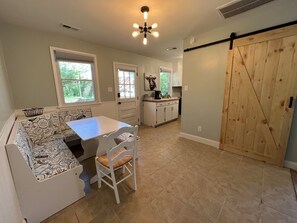 Dining area, washer/dryer behind barn door