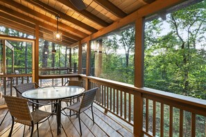 Our furnished screened-in porch. Excellent place to eat breakfast or dinner!