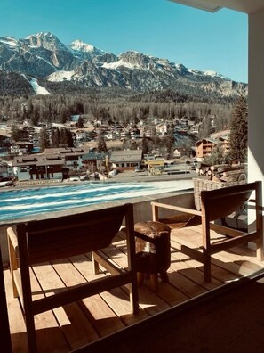 Terrace with deck chairs and views of slopes 