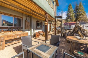 Outdoor living area with firepit and propane grill.