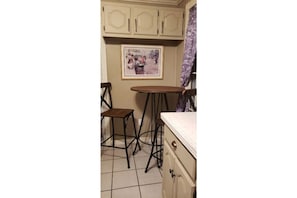 Kitchen has a small table and 2 chairs.