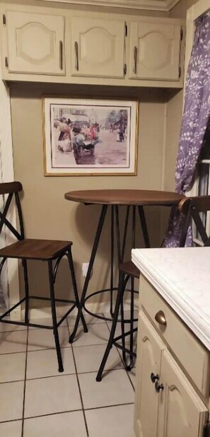 Kitchen has a small table and 2 chairs.
