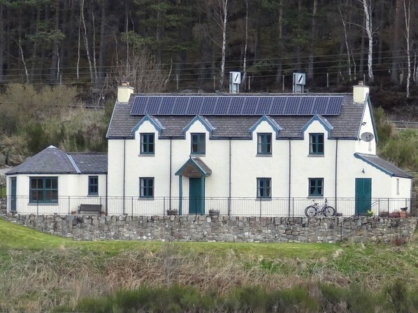 Exterior view with solar panels and lawn