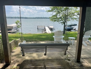 The porch swing is located under the deck.  A bottle openers is in arms-reach :)