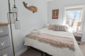 Enjoy a coastal breeze in the upstairs bedroom (Queen bed), Smart TV, AC & fan. 