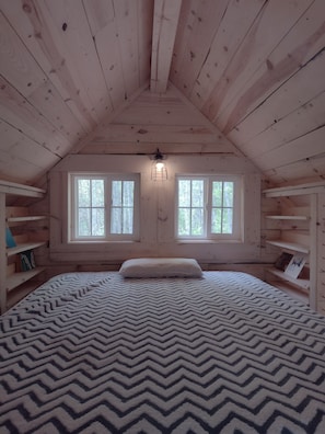 Queen bed in the loft, guests bring linens or sleeping bags.