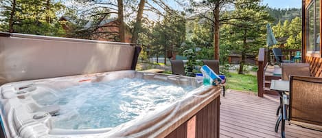 Large hot tub seats six with mountain views.