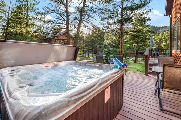 Large hot tub seats six with mountain views.