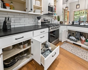 Fully stocked kitchen with pots, pans, baking supplies & serving essentials