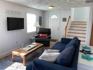 Sofa, recliner, 42" smart TV.