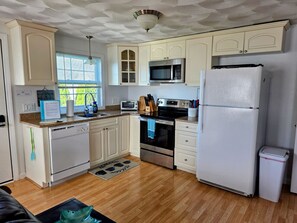 Full kitchen with major appliances, utensils,  coffee maker, toaster oven, blender.