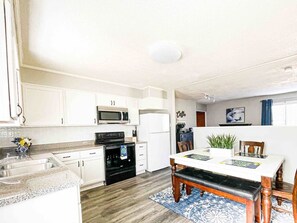 The large fully furnished, eat-in kitchen opens up to the living room 