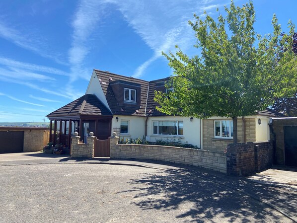 Front facade of house with driveway to the left