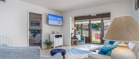 Lovely living room furnishings with access to the heated pool thru the sunroom. Sunroom has blinds for privacy and to keep sun at bay.