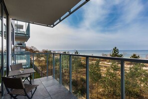 The balcony's stylish design complements the apartment's decor. 