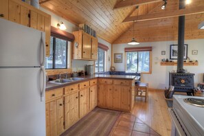 Secluded Mountain Getaway Kitchen - Our kitchen is equipped with an electric range and an open floor plan.
