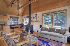 Open living room, dining room and kitchen. - Unwind in the cozy living room while taking in the mountains and National Forest out every window.