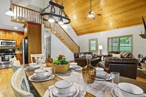 vaulted great room with wood ceilings and dining, seating for 8