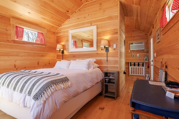 The inviting queen-size bed is dressed in soft, high-quality linens