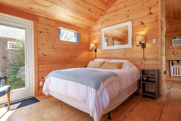 The inviting queen-size bed is dressed in soft, high-quality linens
