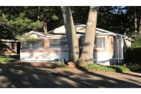 Front view of cabin showing screened in porch.  