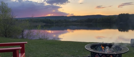 Relax by the lake in 6 Adirondack chairs next to the fire pit. 