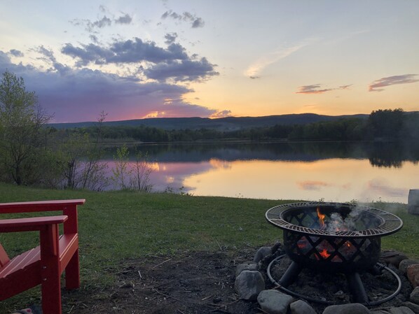 Relax by the lake in 6 Adirondack chairs next to the fire pit. 