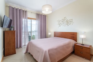 The large bedroom with a full-size bed has a separate exit to the terrace.