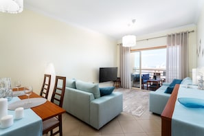 The large living room is equipped with a sofa - bed and a folding bed.