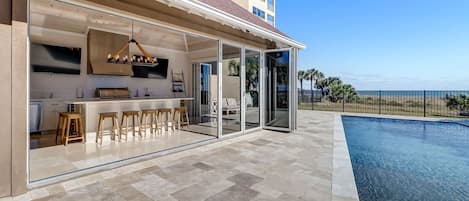 Luxury Indoor/Outdoor Entertaining Space with 2 Flat Screen TV's, a Heated Private Pool, a Fenced in Patio, and Gorgeous Direct Oceanfront Views (Interior Grill Not For Guest Use- Exterior Gas Grill Provided)