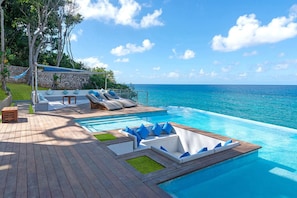 Relax in luxury: Pool, beach lounge, and sea views offer the perfect retreat.