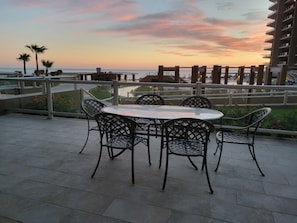 The walkout patio overlooks the lazy river, hot tub, and pool swim-up bar.