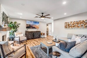 Spacious Living Room with Comfortable Seating and 75" Smart TV