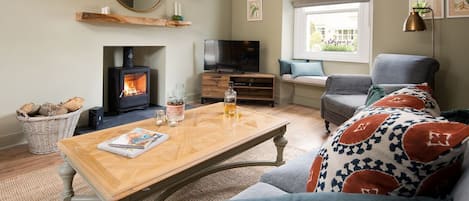 Campsie Cottage - the fire-warmed sitting room is a cosy space to relax with a dram and a classic film