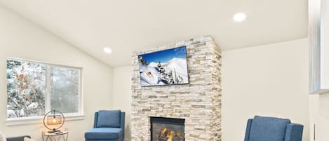 Living room with gas fireplace and smart TV