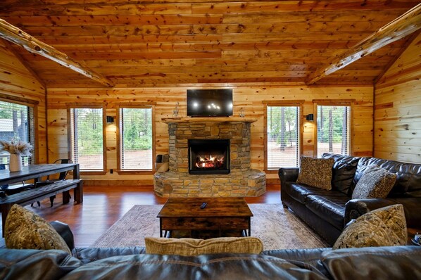 Living Room with TV, Fireplace, Arcade, Pull-Out Couch and Privacy Blinds.