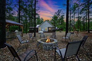 Outdoor Space with firepit, bbq, and swingset.