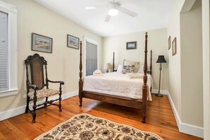 Primary suite with seating and queen bed