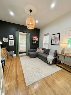 TV room with original floors and doors. 