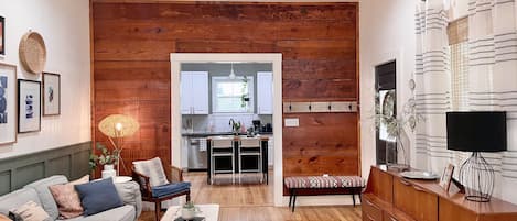 Living Room with original shiplap wall and original floors. 