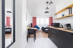 The sleek design of the kitchenette blending seamlessly with the living area.