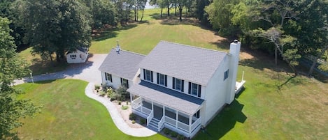 Front of home with view of path to  pier and dock